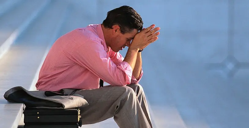 Man sitting on steps with briefcase